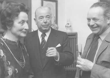 A black-and-white photograph of three people.