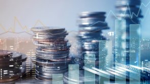 Financial investment broker A daigram, a graphic and a pile of coins in the foreground, a large city in the background